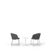 Two modern grey chairs facing each other with a white round table on a white background. (Dark Gray)
