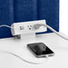 White power strip on blue background with phone charging. 
