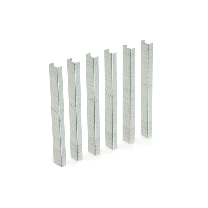 Row of silver metal staples on white background 